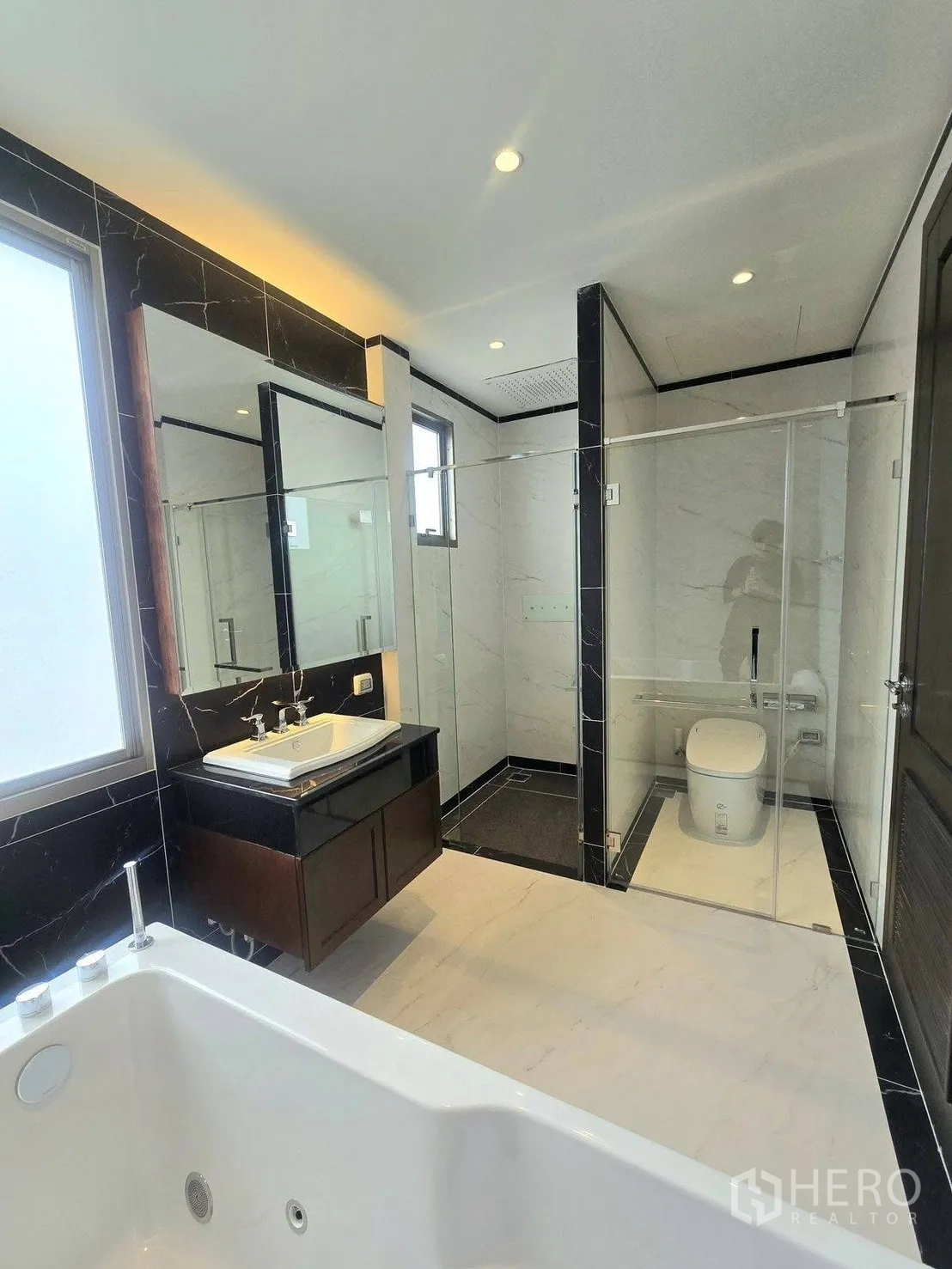 Detached House for rent or sale in Bang Phli, Samut Prakan - Modern bathroom featuring glass-enclosed shower, separate toilet area, wide vanity and tub in the foreground.
