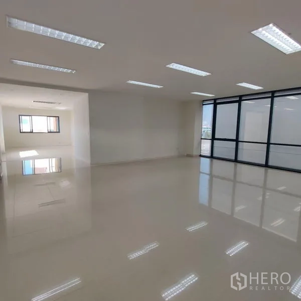 Office Space for rent in Bang Kho Laem, Bangkok - Corner office area with large glazed panels and recessed ceiling lights.