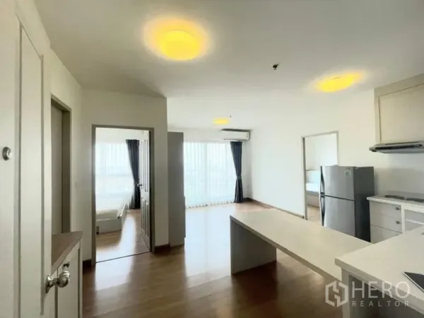 Condominium for sale - White kitchen with breakfast bar, stainless fridge and access to two bedrooms.