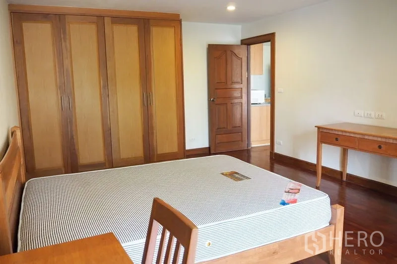 Condominium for rent in Pathum Wan, Bangkok - Second bedroom with built-in wardrobes, study desk and wood flooring