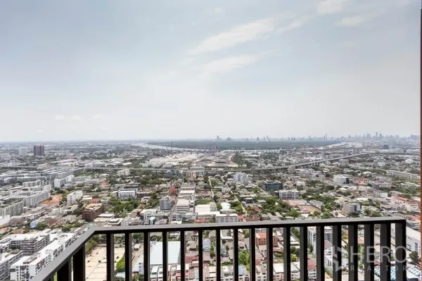Condominium for rent in Phra Khanong, Bangkok - High-floor balcony with panoramic Bangkok skyline and expressway views.