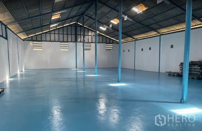 货栈 出租在Bang Pa-in, Phra Nakhon Si Ayutthaya - 仓库内部约400㎡，蓝色环氧地坪，钢柱结构，带天窗与通风窗。