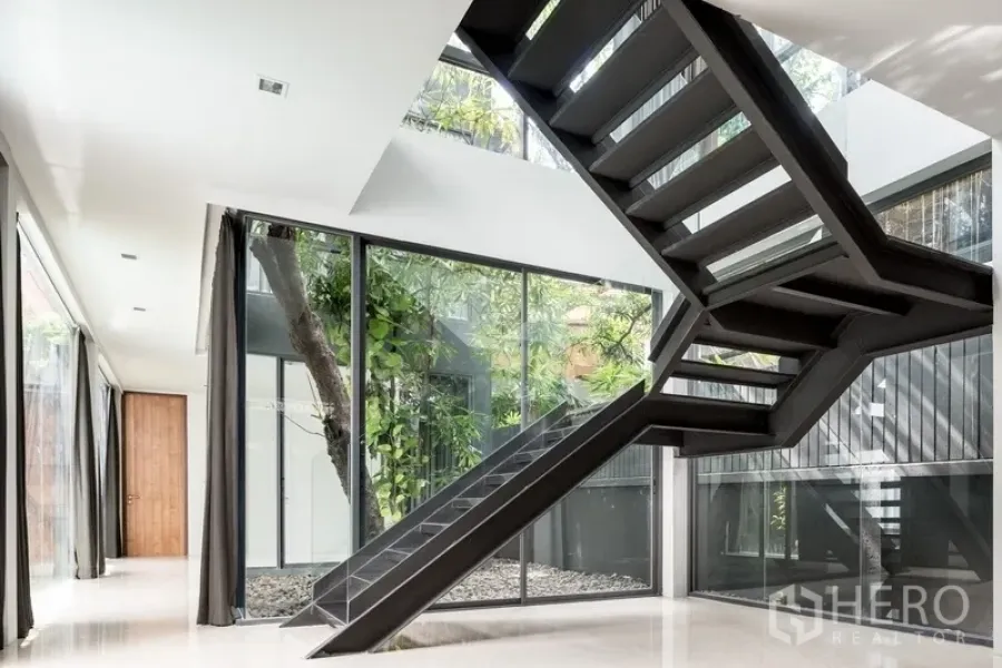 Office Space for rent in Watthana, Bangkok - Bright double-height lobby with black metal staircase and floor-to-ceiling glass.
