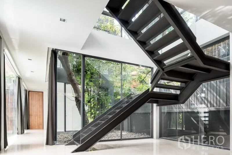 Office Space for rent in Watthana, Bangkok - Bright double-height lobby with black metal staircase and floor-to-ceiling glass.