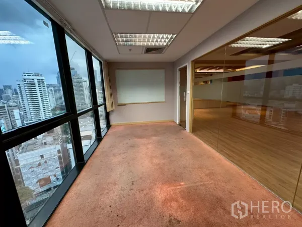Office Space for rent in Khlong Toei, Bangkok - Glass-walled meeting room with carpet flooring and panoramic windows over the city.
