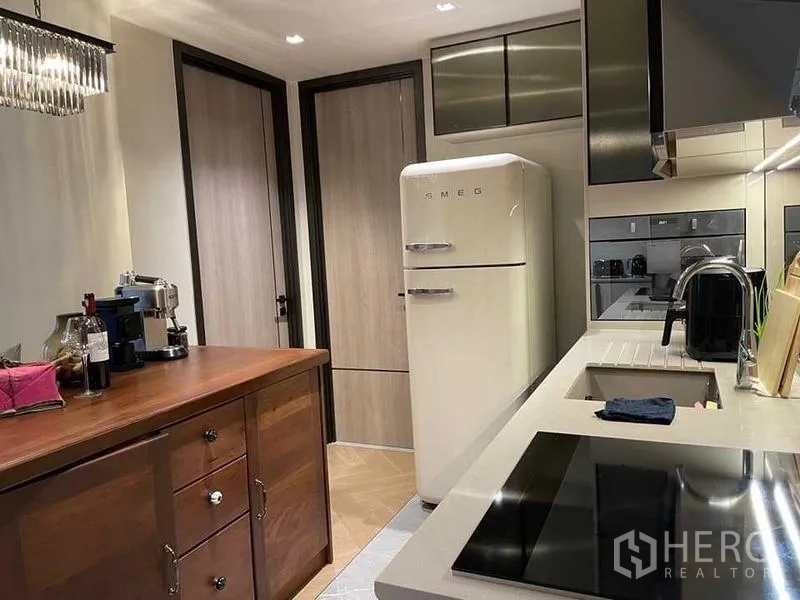 Condominium for rent or sale - Compact kitchen with SMEG fridge, induction hob and storage cabinets
