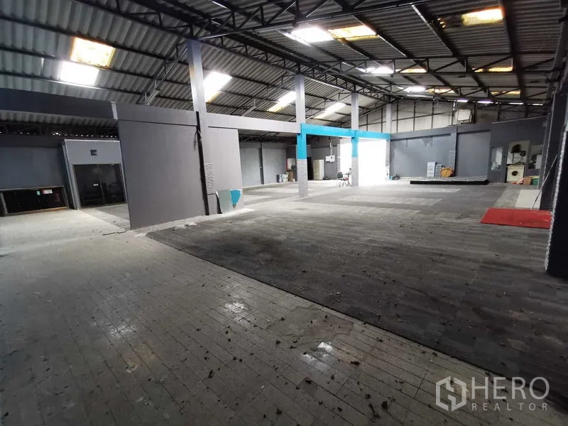 货栈 出租在Nonthaburi - 宽敞仓库区域，钢柱、采光板和抬高平台。