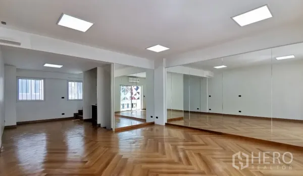 Home Office for rent in Watthana, Bangkok - Spacious home office studio with mirrored wall, herringbone wood floors and LED ceiling lights.