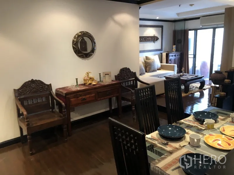 คอนโด ให้เช่าในWatthana, Bangkok - มุมทานอาหารเฟอร์นิเจอร์ไม้แกะสลัก ข้างห้องนั่งเล่นสว่างและประตูระเบียง