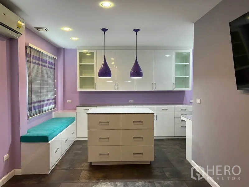 Detached House for rent in Bang Kapi, Bangkok - Bright secondary kitchen or pantry with white cabinets, island and purple accents.