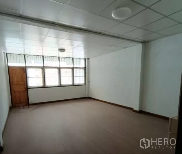 店屋 出租在Bang Rak, Bangkok - 采光良好的房间，整齐吊顶与木纹地面。