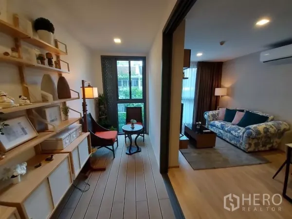 Condominium for rent in Watthana, Bangkok - Bright study with built-in shelves and a bistro set by the window, facing the living room.