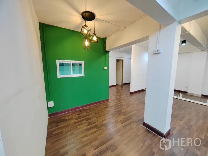 พื้นที่ขายปลีก ให้เช่าในKhlong Toei, Bangkok - มุมต้อนรับเล็กพร้อมโคมไฟห้อยและผนังสีเขียว