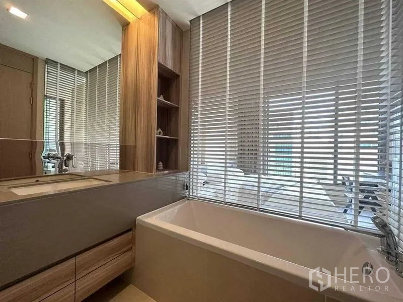 Condominium for rent in Watthana, Bangkok - Bathroom with soaking tub, wood cabinetry and window blinds