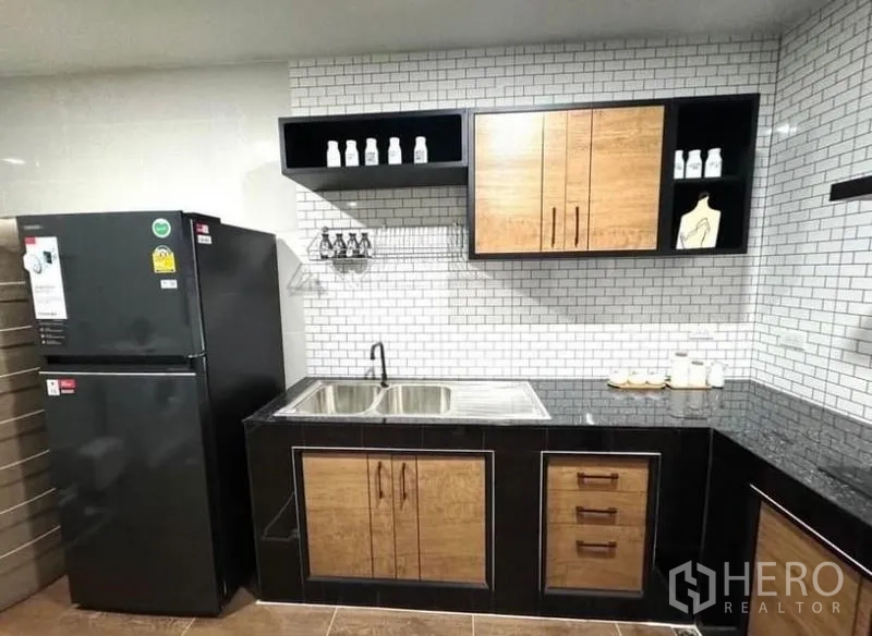 Townhouse for rent - Kitchen sink and cabinetry detail with floating shelves and tiled backsplash.