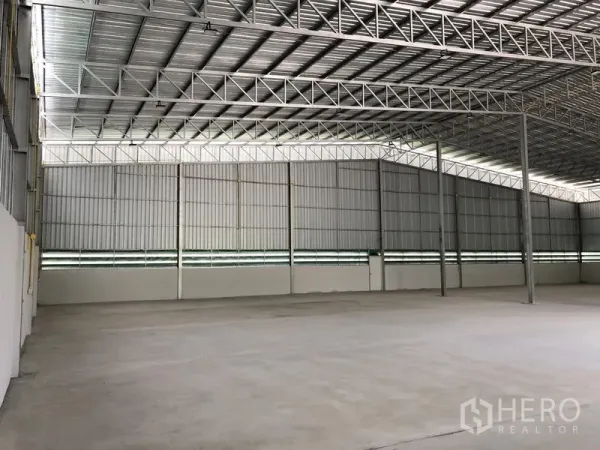 Warehouse for rent in Lat Lum Kaeo, Pathum Thani - Open storage hall showing steel columns and natural light panels.