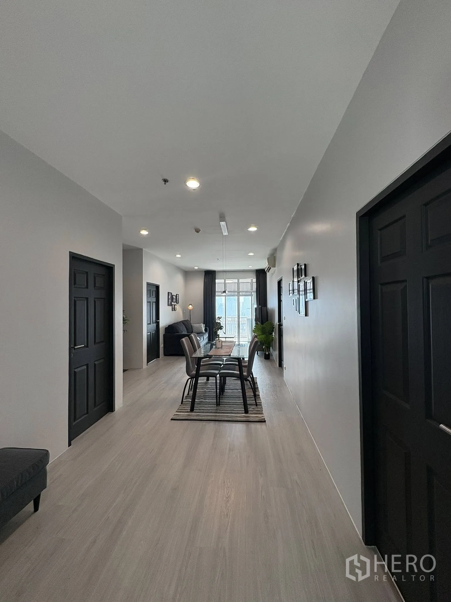 คอนโด for rent in Ratchathewi, Bangkok - มุมมองตามโถงยาวไปยังโต๊ะทานข้าวและห้องนั่งเล่นที่สว่าง