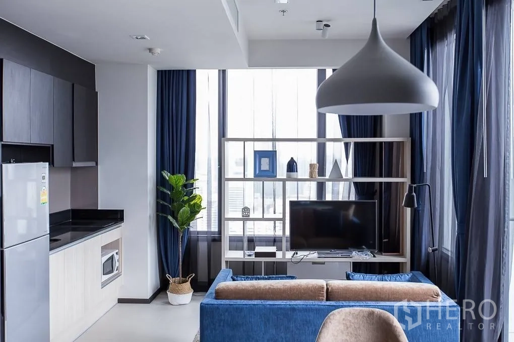 คอนโด ให้เช่าหรือขายในWatthana, Bangkok - ห้องนั่งเล่นชั้นสูง ผ้าม่านสีน้ำเงิน ชั้นวางทีวี และครัวบิลท์อิน ที่ EDGE สุขุมวิท 23