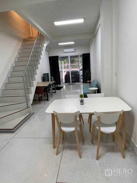 Home Office for rent or sale in Watthana, Bangkok - Townhome frontage with covered carport and sliding glass entry, gate open.