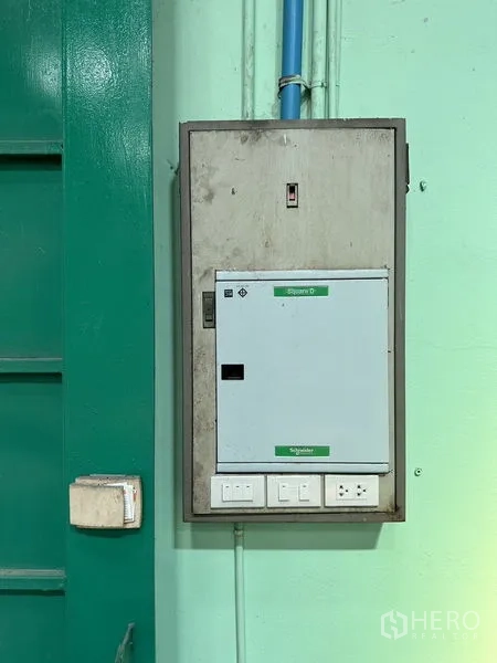 Factory for rent in Bang Bo, Samut Prakan - Industrial electrical control panel with outlets mounted on a mint-green wall.