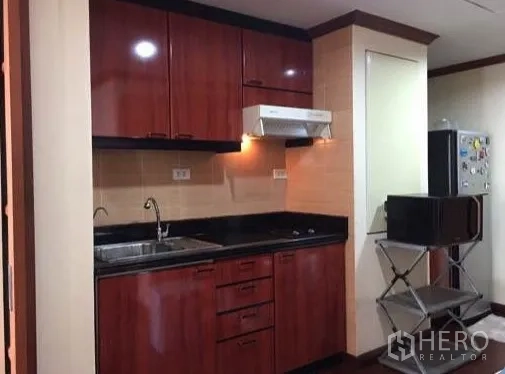 คอนโด ให้เช่าหรือขายในWatthana, Bangkok - มุมมองครัวกว้างขึ้น พร้อมช่องวางตู้เย็นและผนังสีเบจ