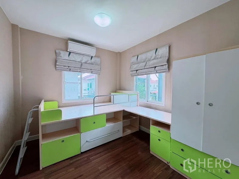 Detached House for rent in Prawet, Bangkok - Children’s bedroom with corner study desks, storage units, and windows.