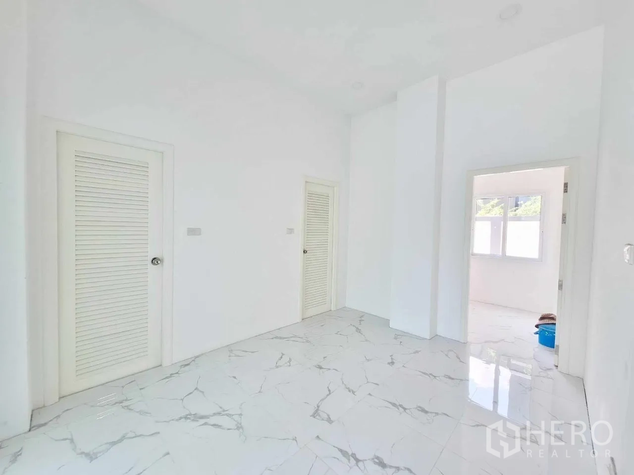 Office Space for sale in Bueng Kum, Bangkok - Hallway landing with marble floors and built-in storage doors.