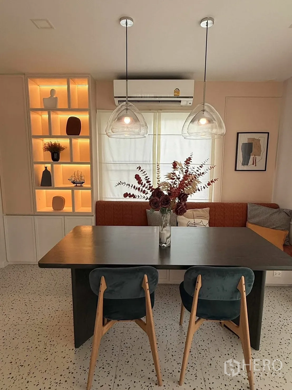 Detached House for rent in Bang Phli, Samut Prakan - Dining area with pendant lights, backlit display shelves and bench seating.
