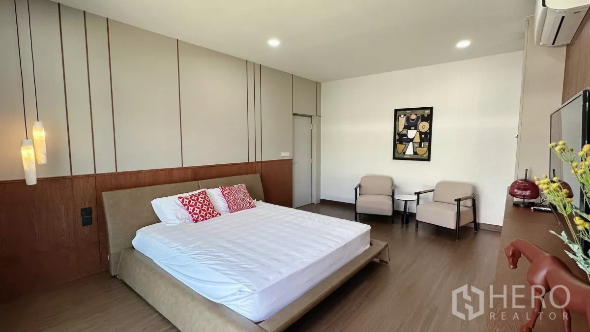 Detached House for rent in Bang Phli, Samut Prakan - Master bedroom view showing king bed with pendant lights and armchairs.