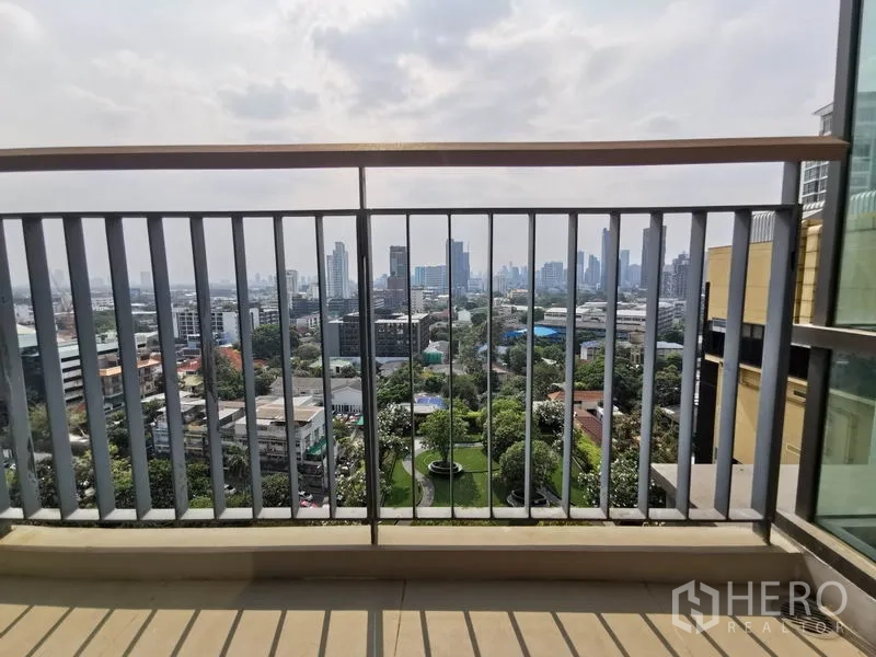 Condominium for rent in Khlong Toei, Bangkok - Private balcony railing framing a panoramic view over Bangkok and green spaces below.