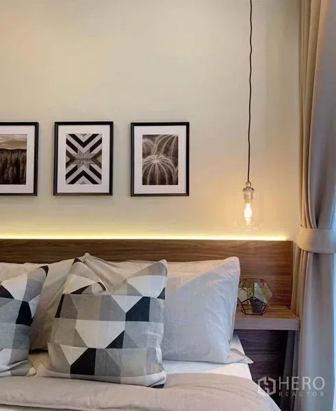 Condominium for sale in Ratchathewi, Bangkok - Cozy bedroom with headboard LED lighting, framed art and a bedside pendant.