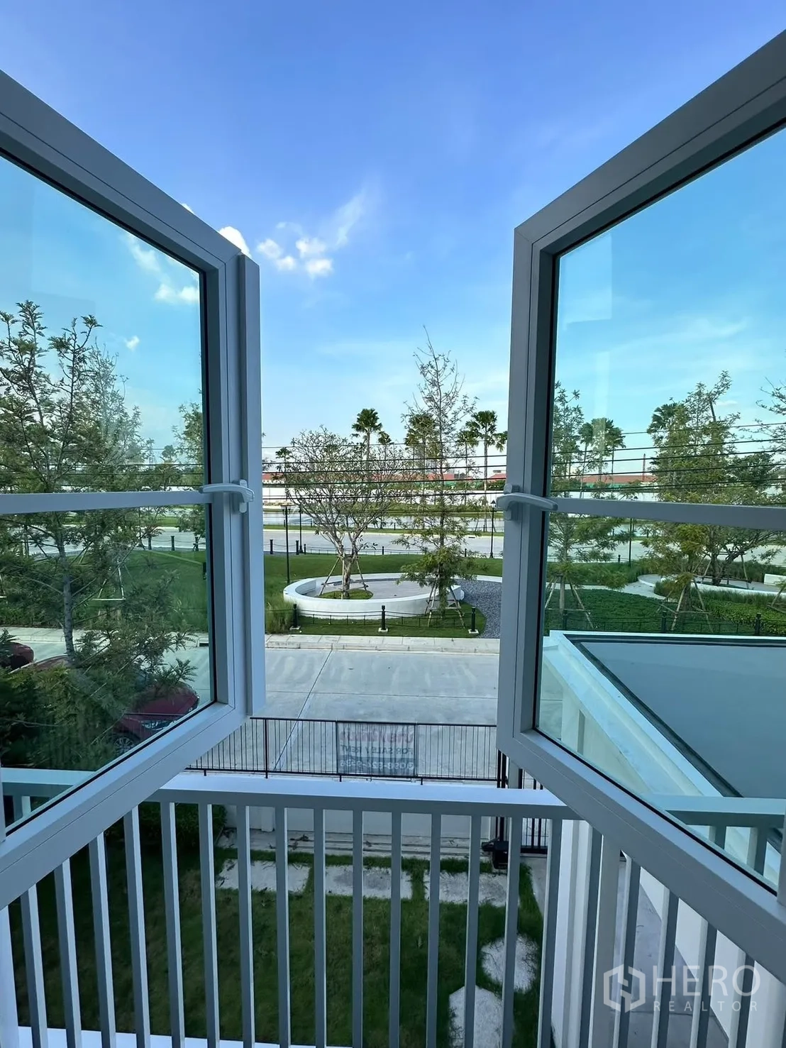 Detached House for rent in Bang Phli, Samut Prakan - Open casement windows with a view of landscaped streets and trees.