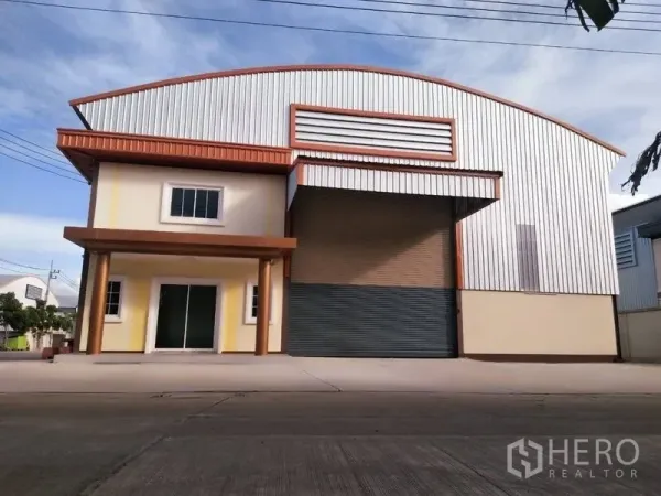 Warehouse for rent or sale in Nakhon Pathom - Modern steel-clad warehouse with attached two-storey office, wide roller shutter and driveway in Bang Len.