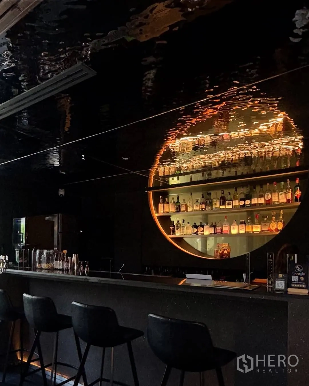 Retail Space for rent in Watthana, Bangkok - Backlit bottle display behind sleek black bar with high stools.