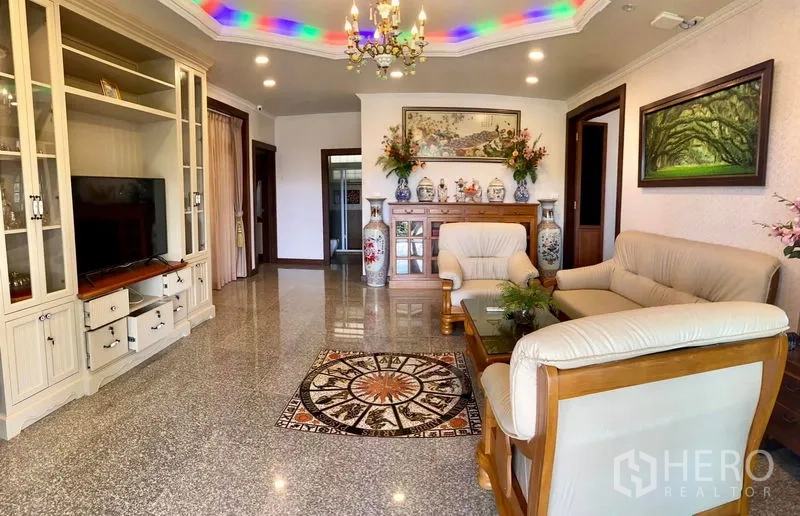 Detached House for sale in Bang Bo, Samut Prakan - Spacious living room with built-in cabinetry, chandelier, and sofa set.