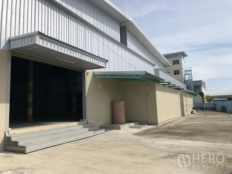 Factory for rent or sale in Bang Phli, Samut Prakan - Loading dock with raised platform, canopy cover, and wide concrete yard beside the warehouse.