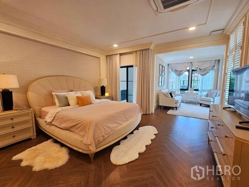 Detached House for rent or sale in Saphan Sung, Bangkok - Grand master bedroom with herringbone wood floor and a connected lounge area.