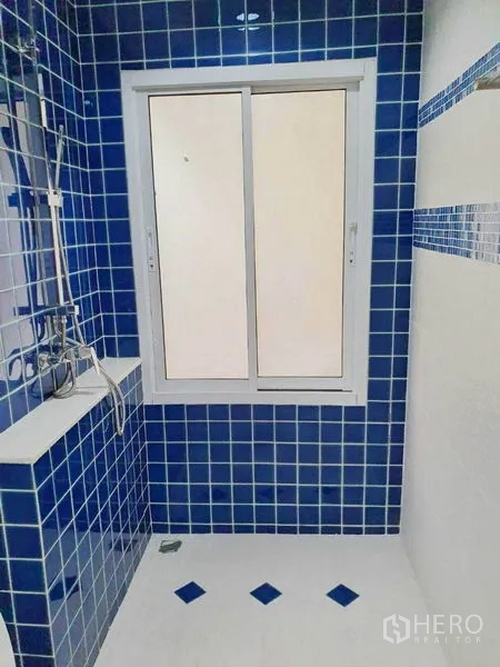 Detached House for sale in Taling Chan, Bangkok - Shower area with blue mosaic tiles and a sliding window.