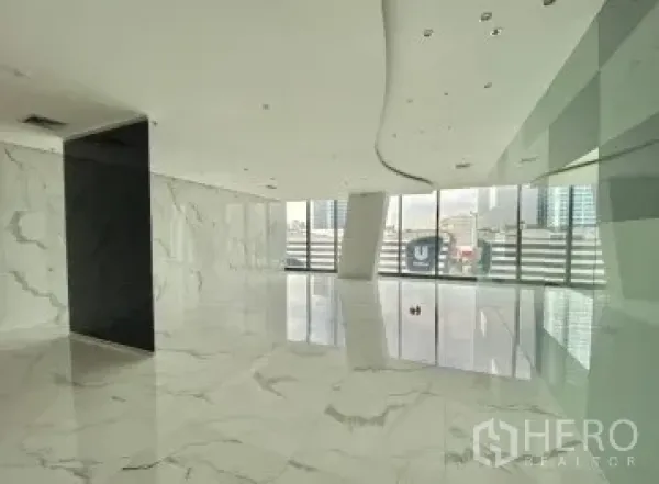 Office Space for rent - Bright lobby-style office area with marble-look floors, curved ceiling, glass wall and city skyline views.