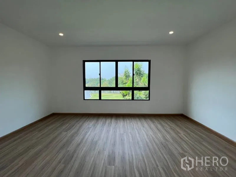 Townhouse for rent in Bang Kapi, Bangkok - Large bedroom with panoramic window offering park-like green views.