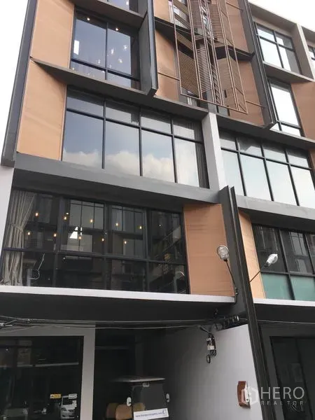 Home Office for rent or sale in Suan Luang, Bangkok - Modern multi-storey home office facade with large windows and wood-accent panels in Suan Luang.