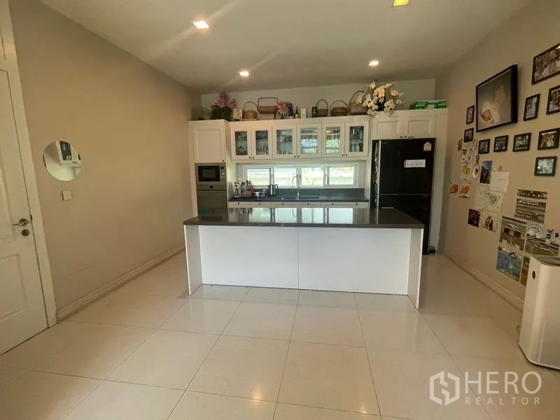 独立式住宅 出租在Bang Phli, Samut Prakan - 现代白色厨房，中岛台、玻璃柜与嵌入电器