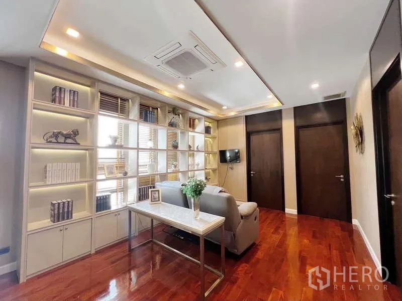Detached House for rent or sale in Bang Phli, Samut Prakan - Upstairs family room with long illuminated bookcase and work desk.