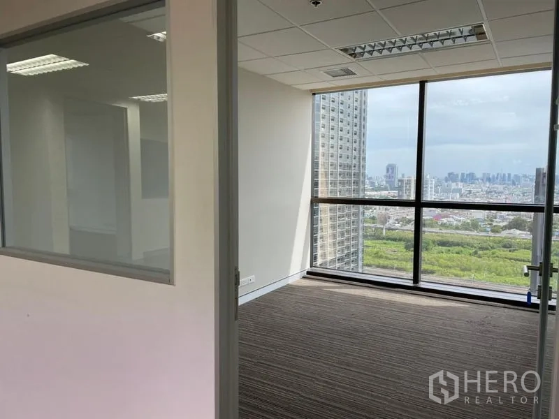 Office Space for rent - Small glass-partitioned office leading to a windowed room with skyline and park views.
