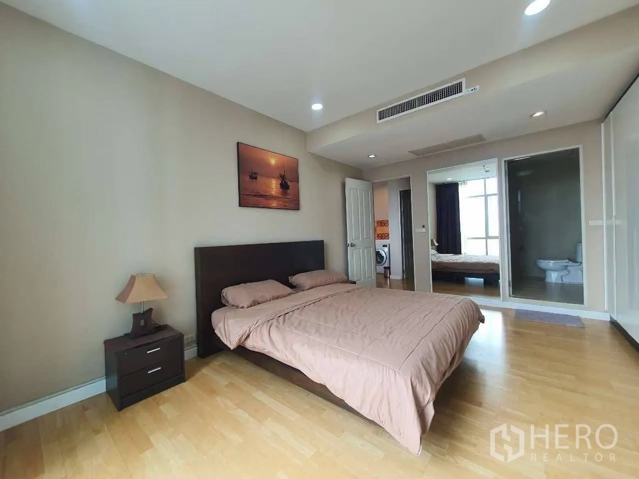 公寓 for rent in Khlong San, Bangkok - 主卧宽敞，配特大床、床头柜、木地板，并可见带卫浴套间。