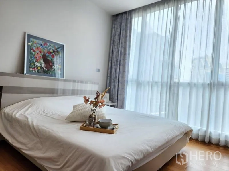 公寓 出租在Watthana, Bangkok - 采光充足的卧室，落地窗、纱帘与白色床品。