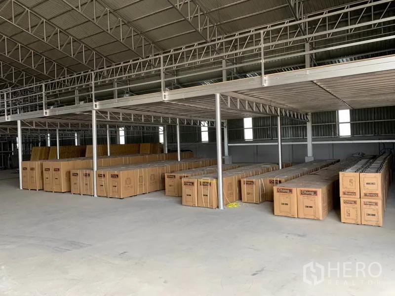 Warehouse for sale in Phra Nakhon Si Ayutthaya - Ground-floor storage area under the mezzanine with neatly arranged boxes.