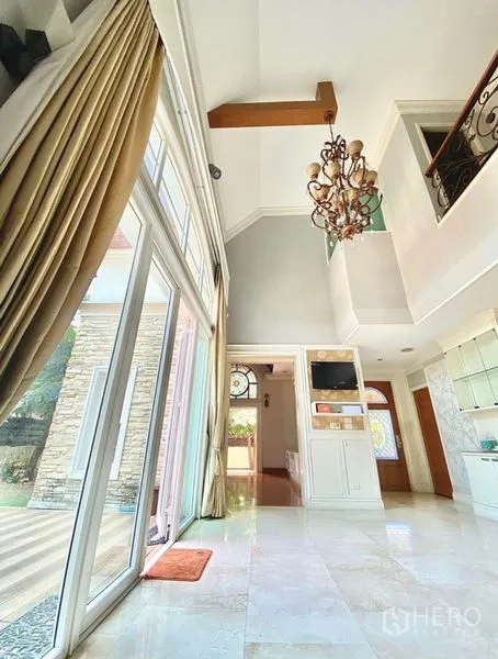 Home Office for rent in Pak Kret, Nonthaburi - Lounge with dark coffered ceiling, stained-glass arched window and built-in media cabinet.