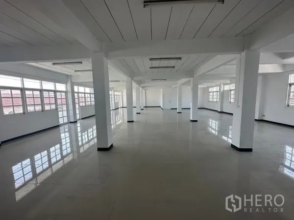 Home Office for rent in Phra Khanong, Bangkok - Bright open-plan office floor with white columns, large windows and glossy tiles.
