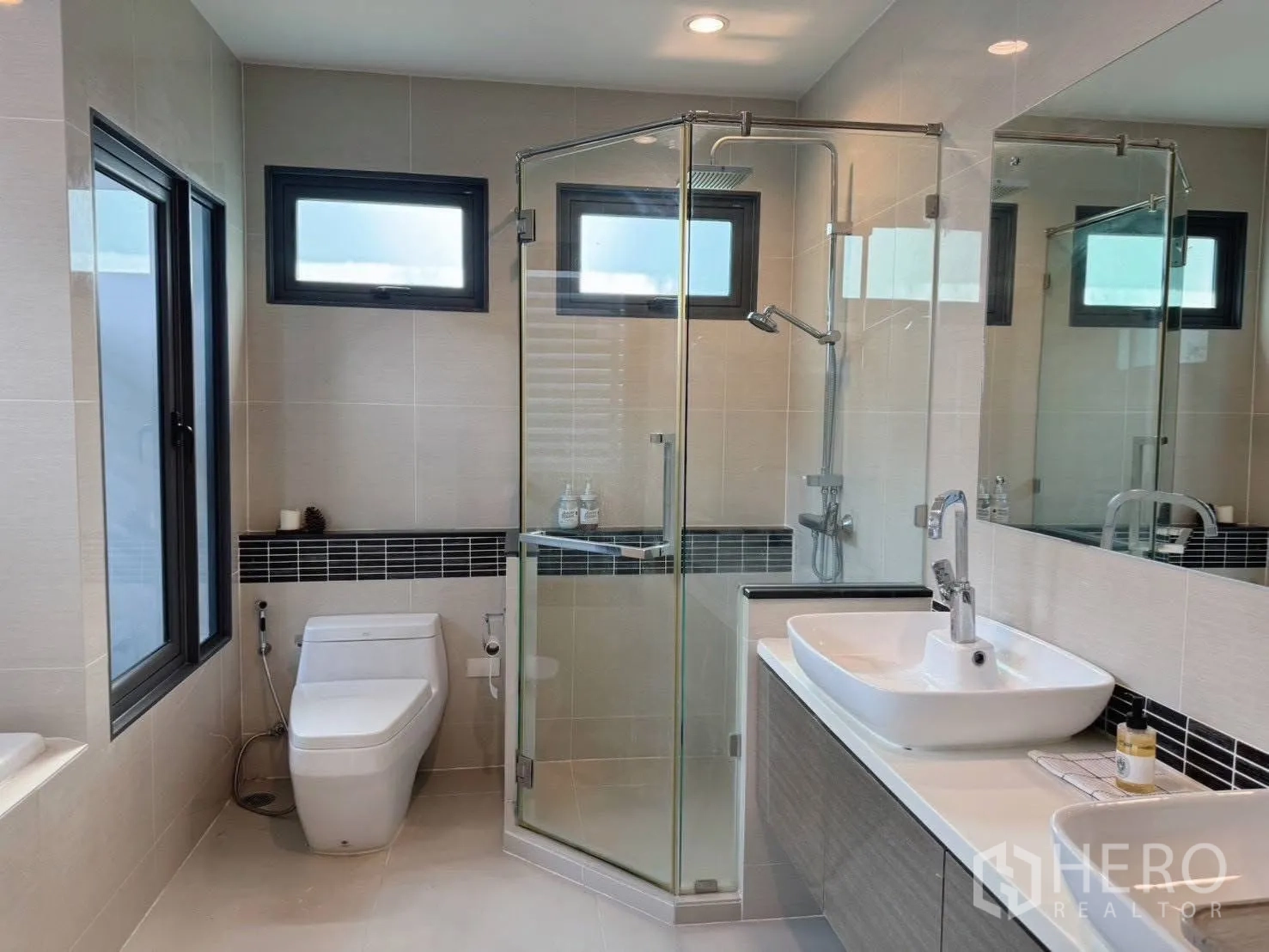 Detached House for rent or sale in Suan Luang, Bangkok - Bright bathroom with glass shower, vanity and modern fixtures.